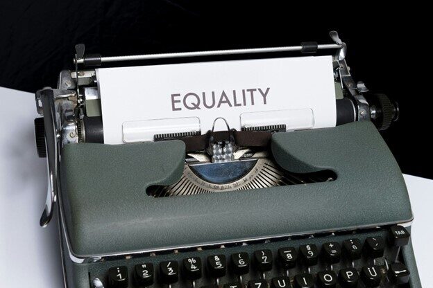 Typewriter with a page coming out saying "equality"